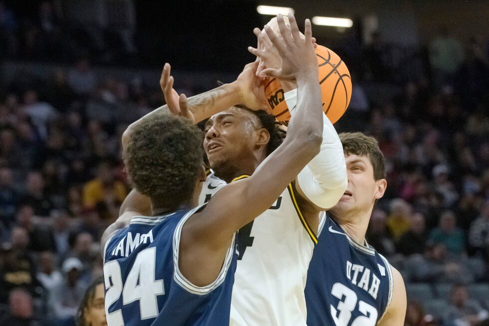 Utah State forward Zee Hamoda (24) and center Trevin Dorius (32) battle for a rebound with...