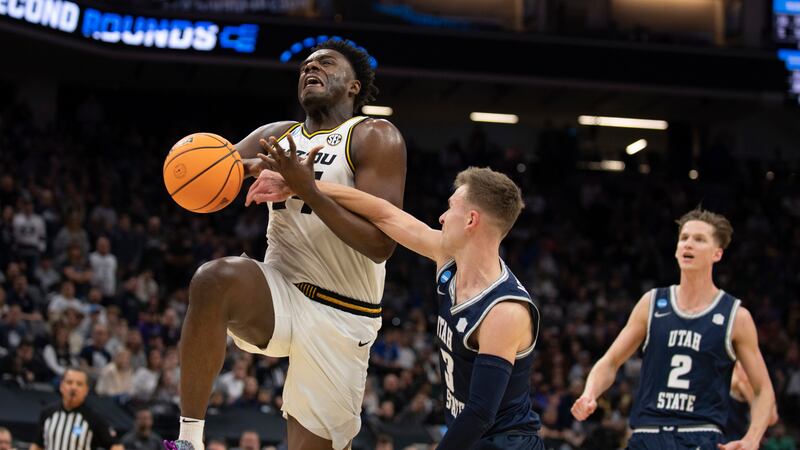 Missouri guard Kobe Brown (24) is fouled by Utah State guard Steven Ashworth (3) during the...