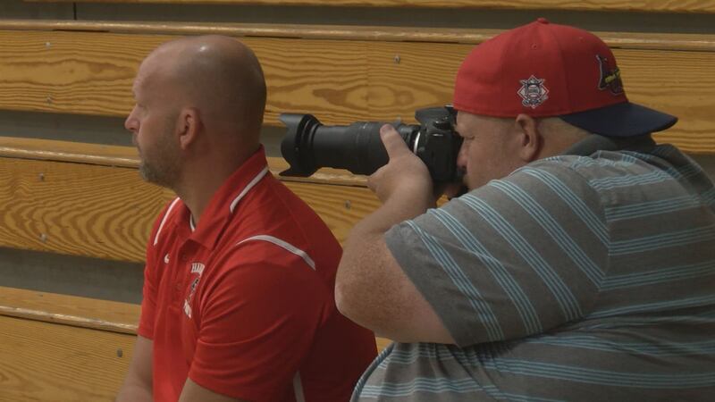 Matt Schuckman taking photos at a QND volleyball game.
